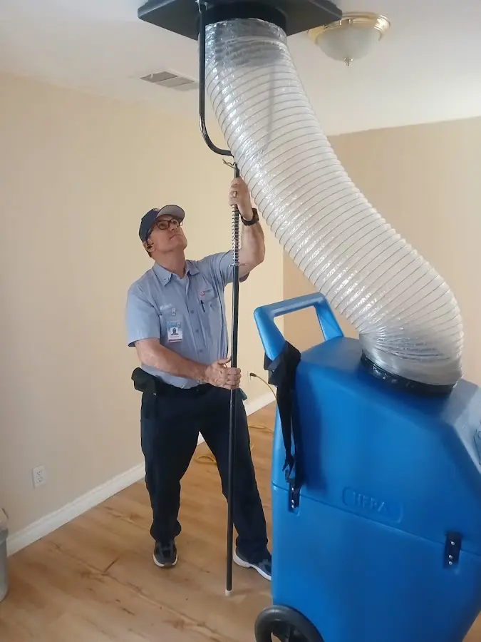Furnace Tune-Up technician using HEPA equipment in Harlingen